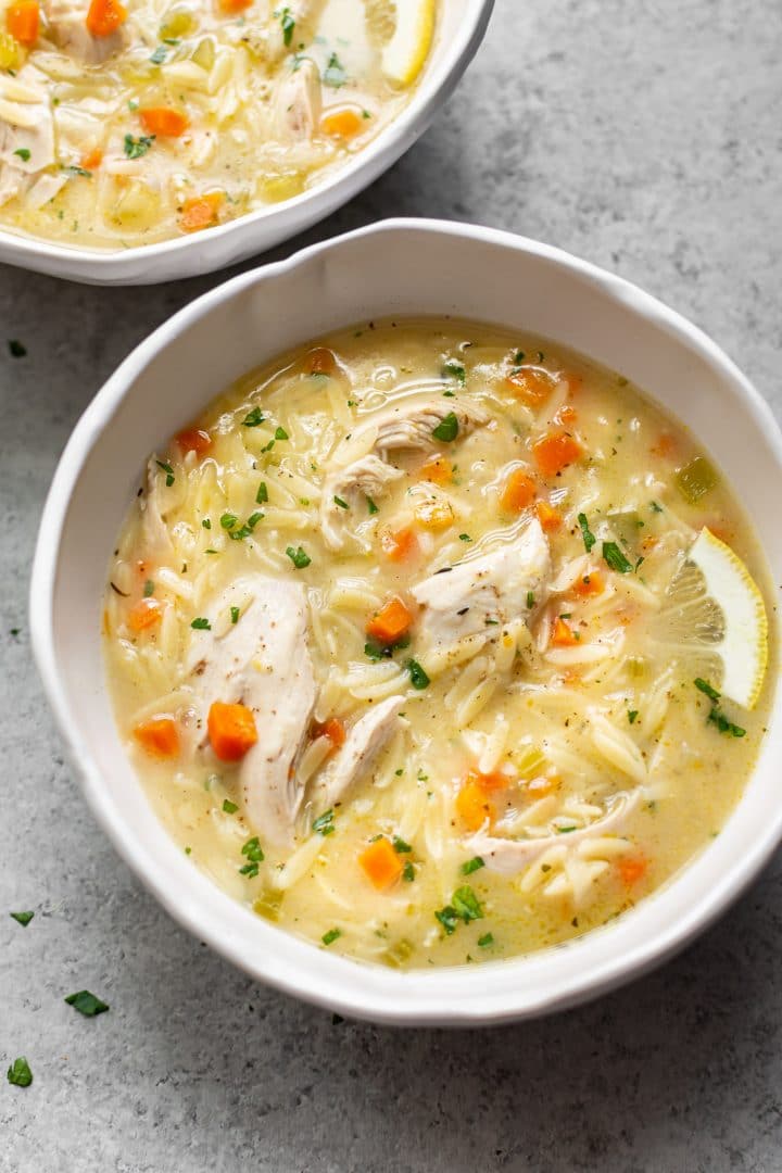 easy lemon chicken orzo soup in two bowls