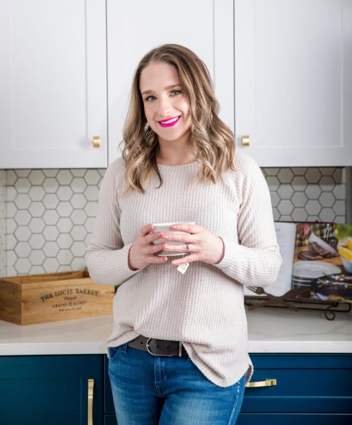 Natasha Bull, founder of Salt & Lavender food blog holding a cup of tea in the kitchen