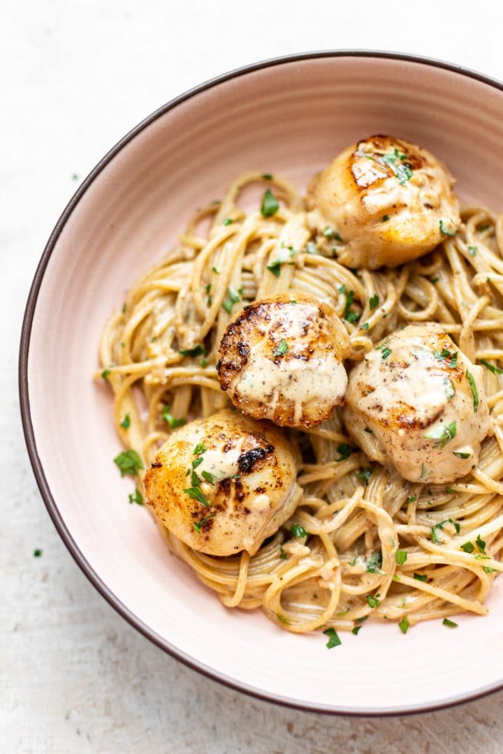 pan seared scallops with creamy lemon garlic sauce over spaghetti