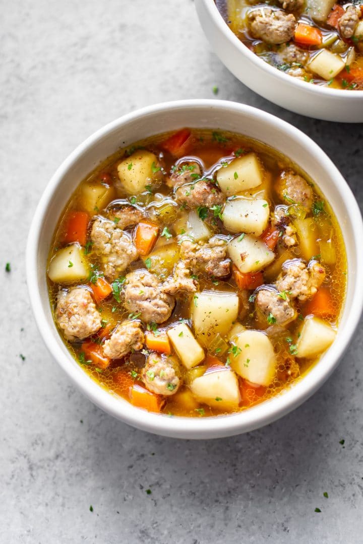 bratwurst soup in two white bowls