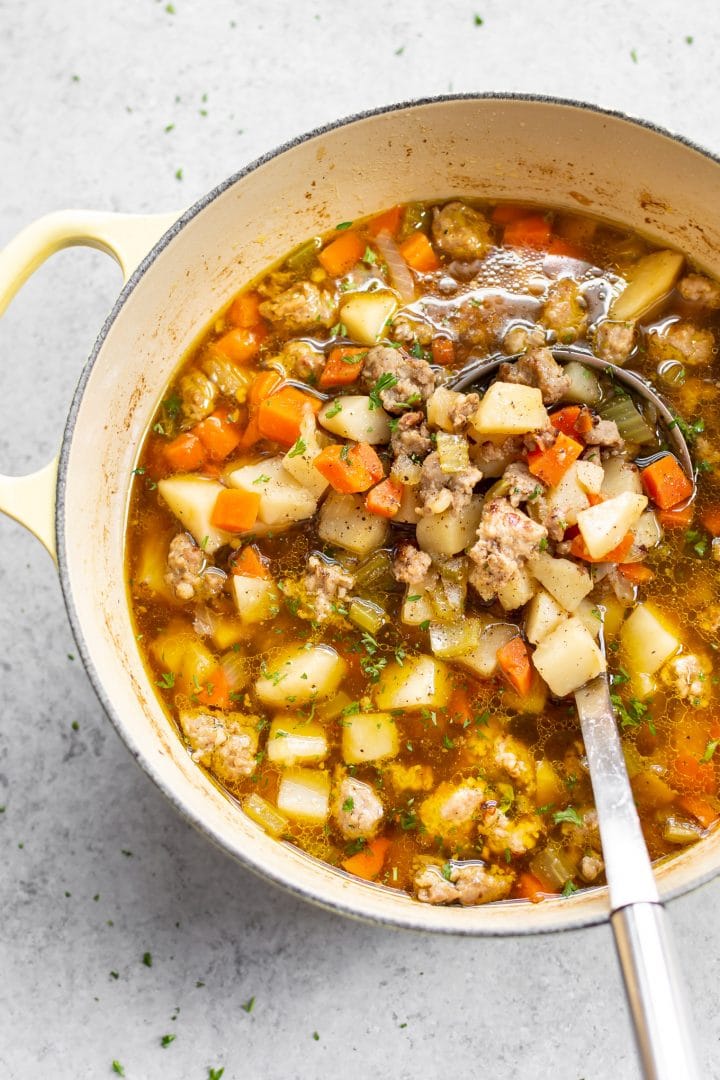 bratwurst soup in a yellow Le Creuset pot