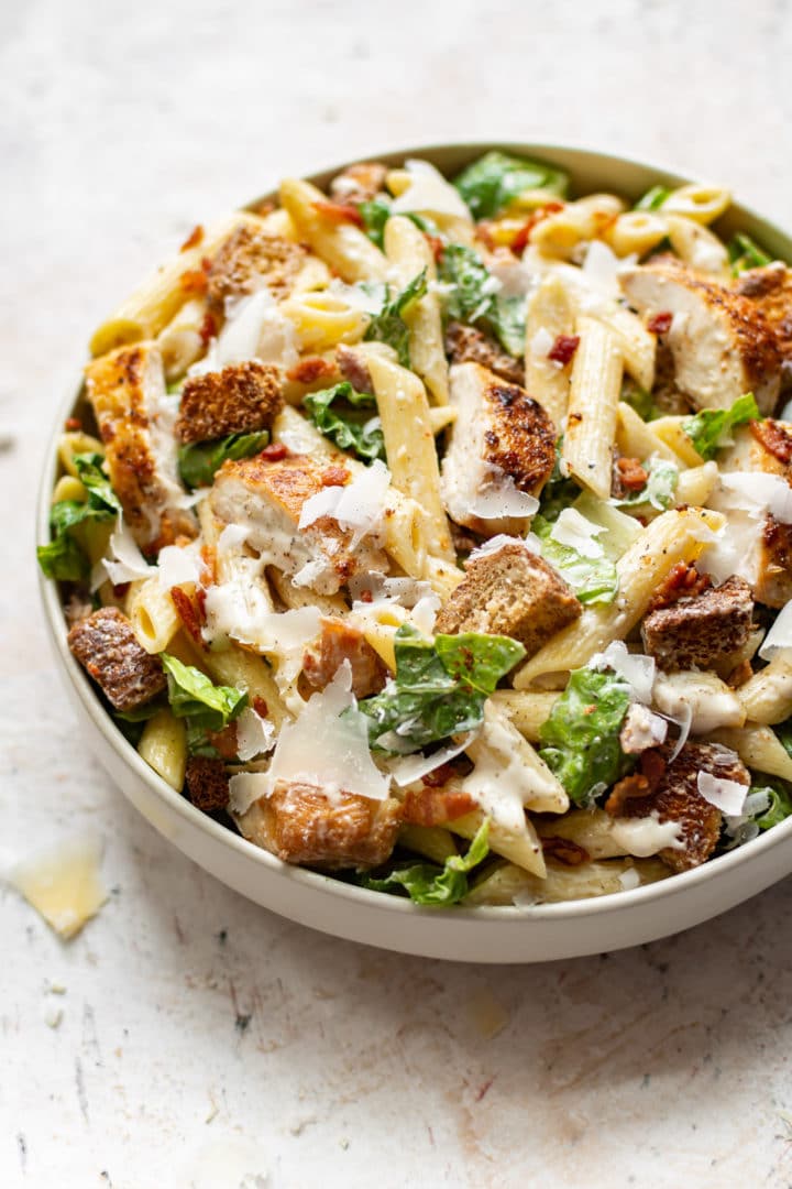 chicken caesar pasta salad in a white bowl