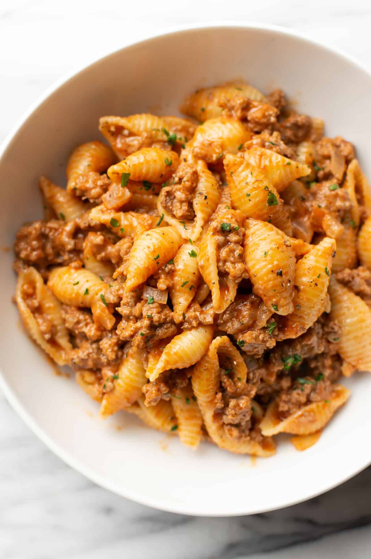 a bowl of creamy beef and shells pasta