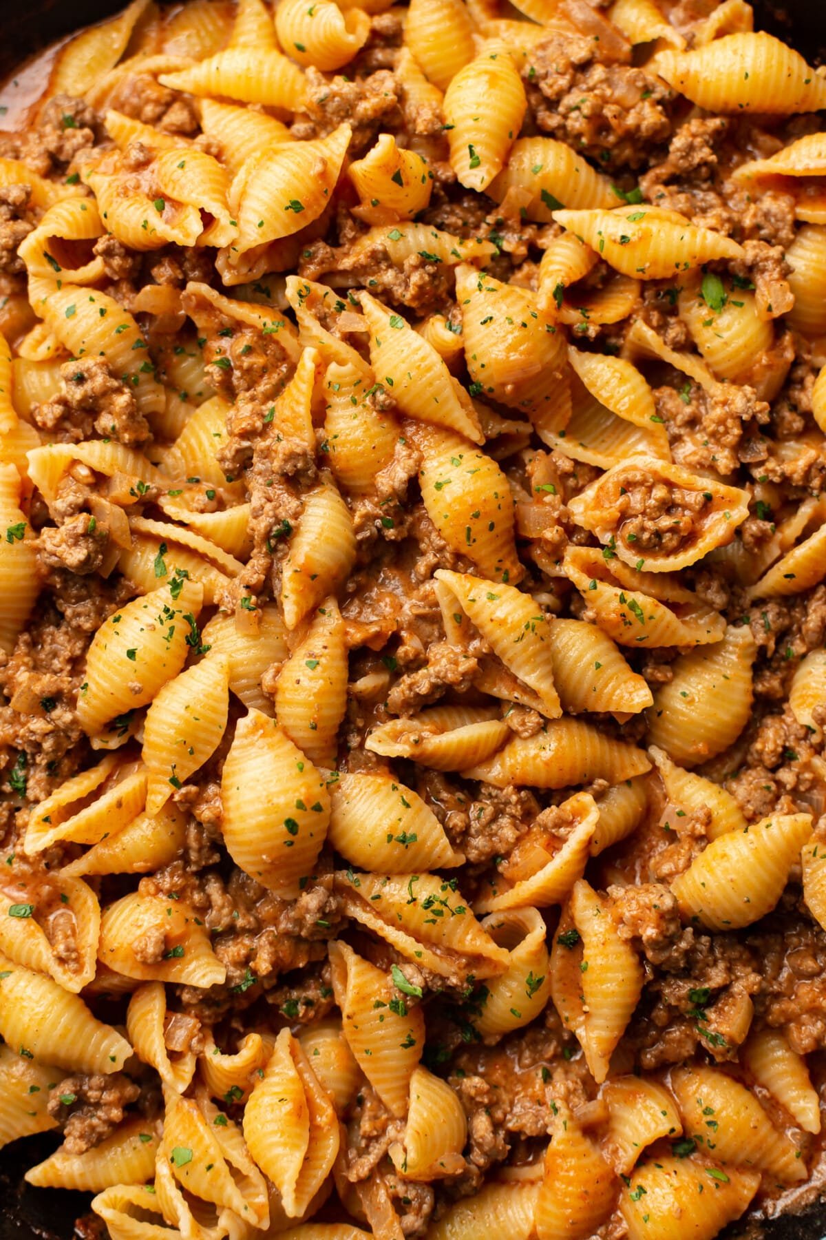 closeup of a skillet with pasta in a creamy beef sauce