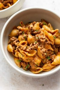 close-up of creamy ground beef and shells in a bowl