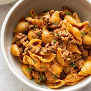 close-up of creamy ground beef and shells in a bowl