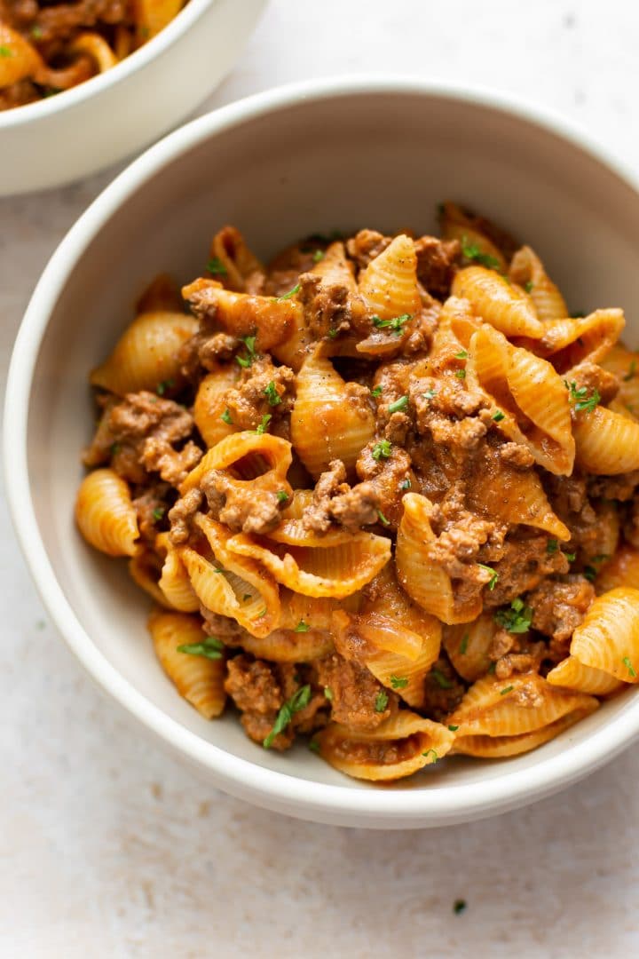 close-up of creamy ground beef and shells in a bowl