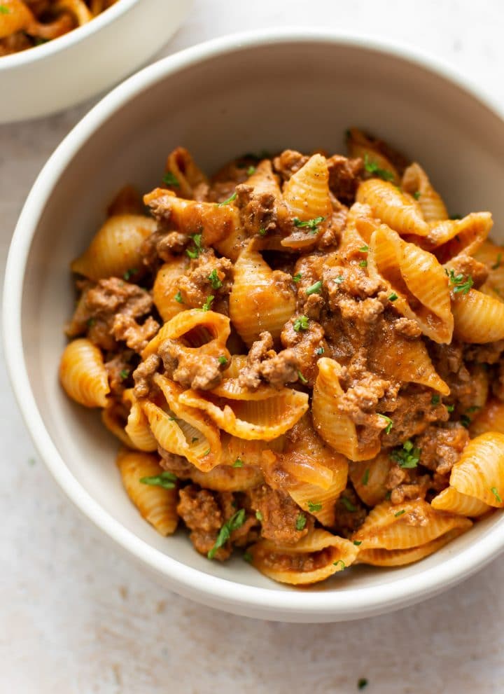close-up of creamy ground beef and shells in a bowl
