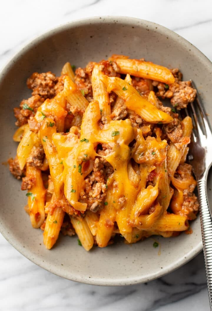 a bowl of ground beef casserole with a fork