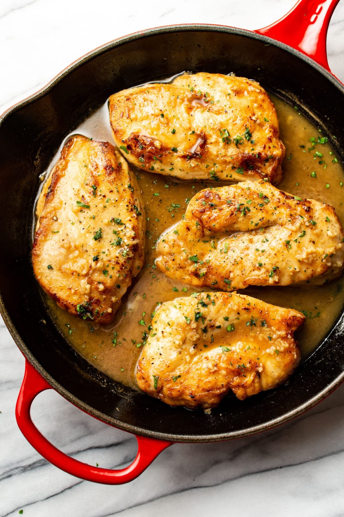 a skillet with honey soy sauce chicken