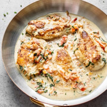creamy tomato and basil chicken in a skillet