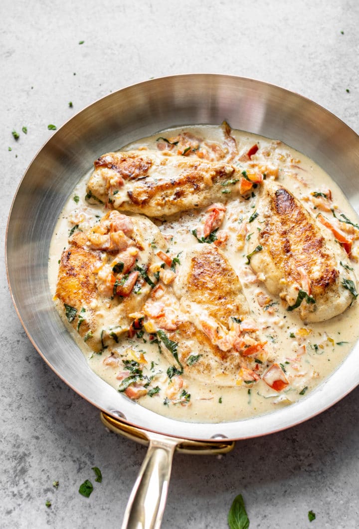 creamy tomato and basil chicken in a skillet