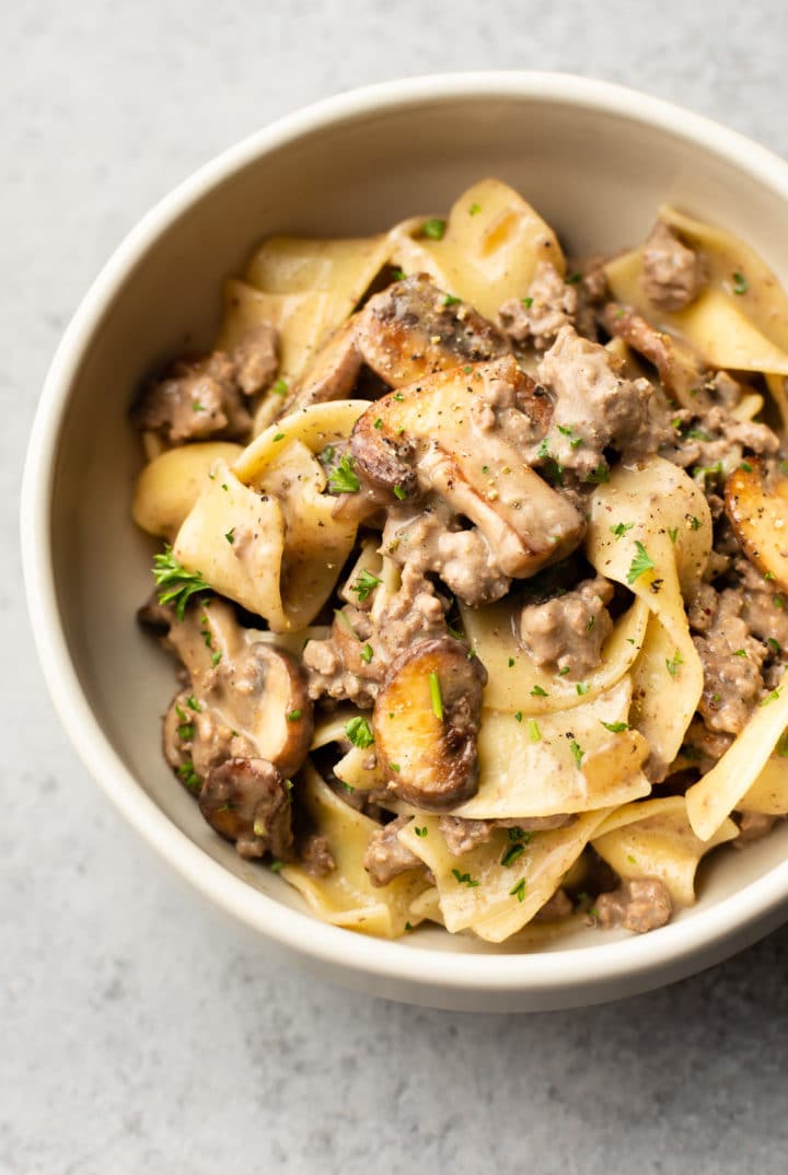 ground beef stroganoff with egg noodles in a white bowl