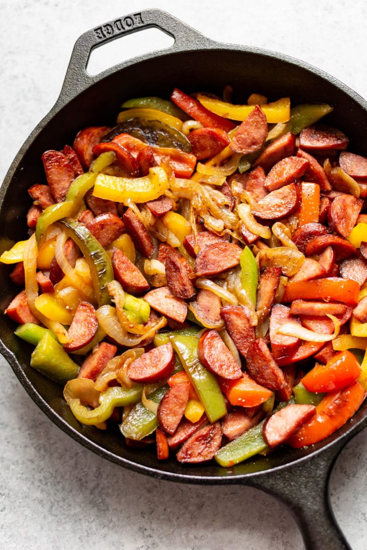 sausage peppers and onions in a cast iron skillet