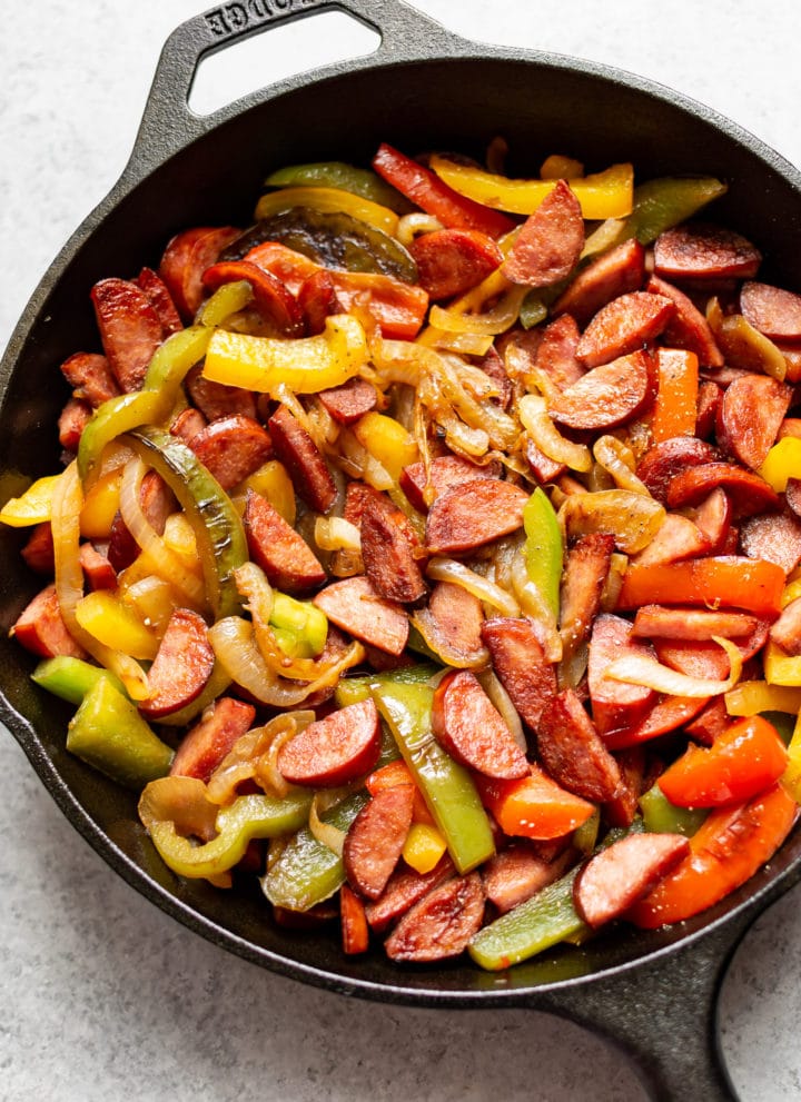 sausage peppers and onions in a cast iron skillet