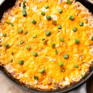 warm Rotel sausage dip in a cast iron skillet surrounded by tortilla chips
