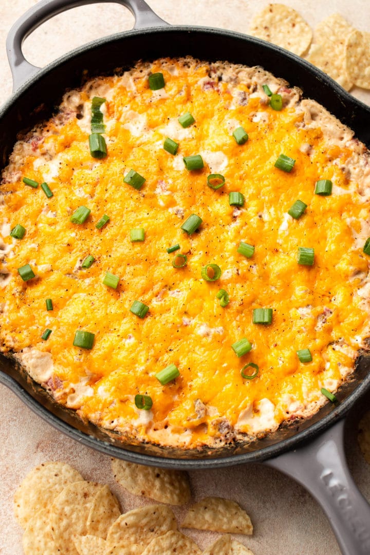 warm Rotel sausage dip in a cast iron skillet surrounded by tortilla chips