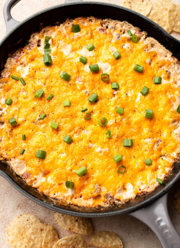 warm Rotel sausage dip in a cast iron skillet surrounded by tortilla chips