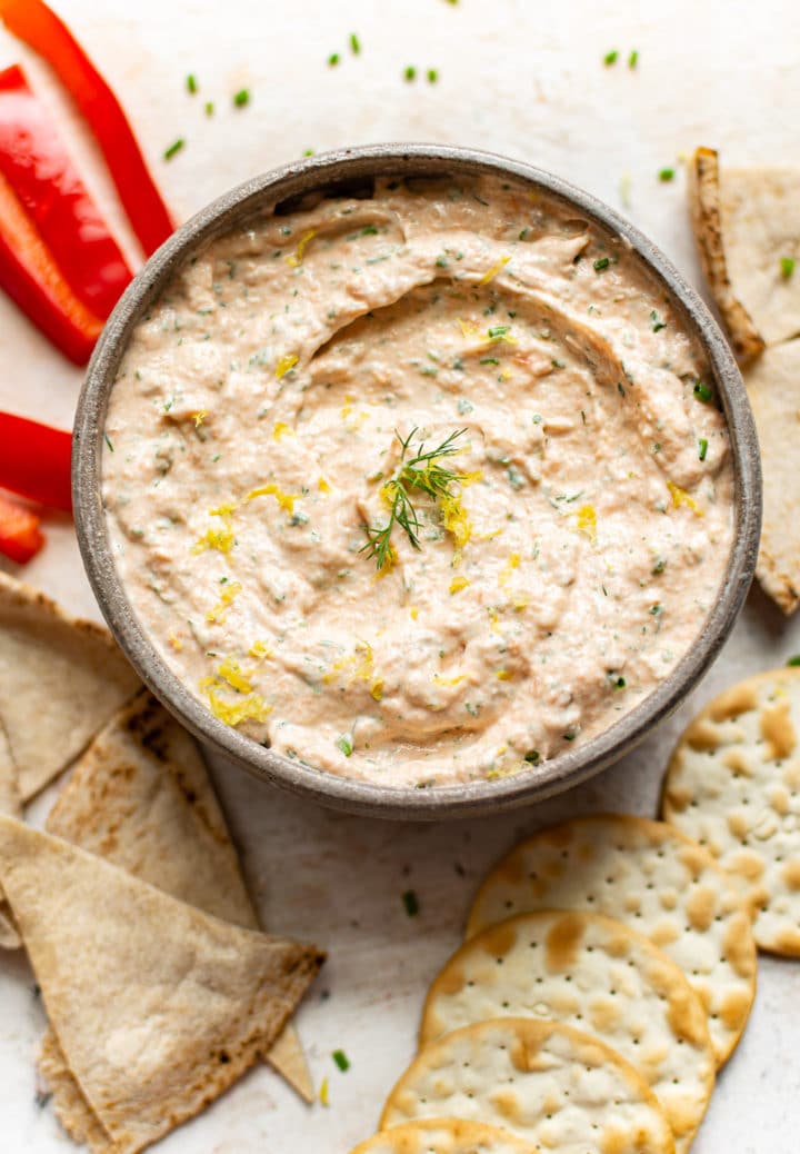 the BEST smoked salmon dip surrounded by red bell peppers, pita bread, and crackers