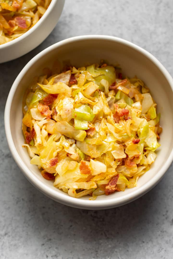 cabbage with bacon and onions in two bowls