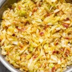 cabbage and bacon in a stainless steel skillet