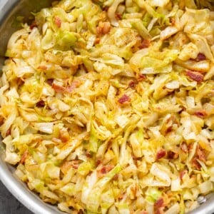 cabbage and bacon in a stainless steel skillet