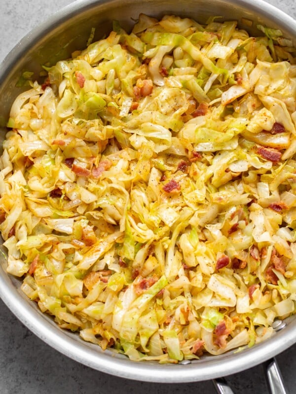 cabbage and bacon in a stainless steel skillet