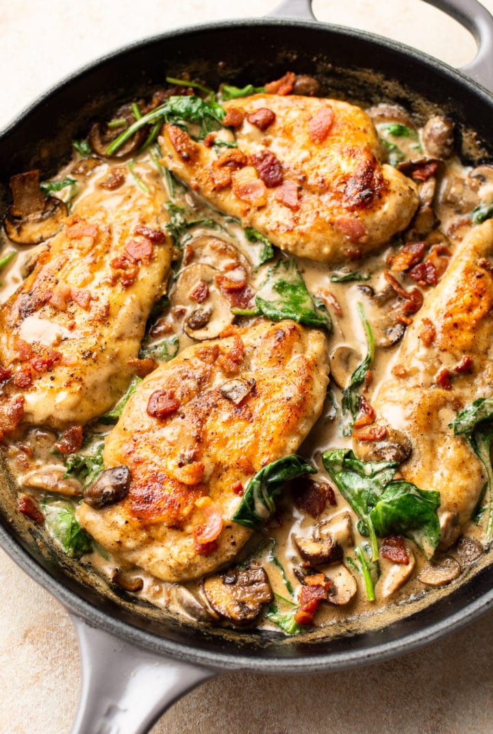 creamy bacon mushroom chicken in a Le Creuset skillet