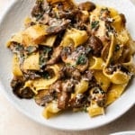 garlic butter mushroom pasta in two white bowls