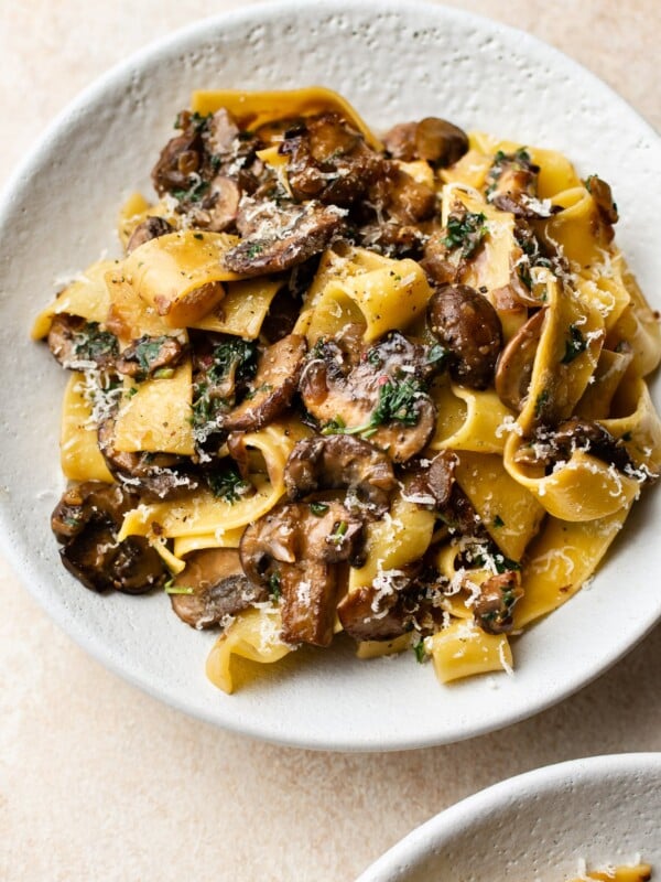 garlic butter mushroom pasta in two white bowls