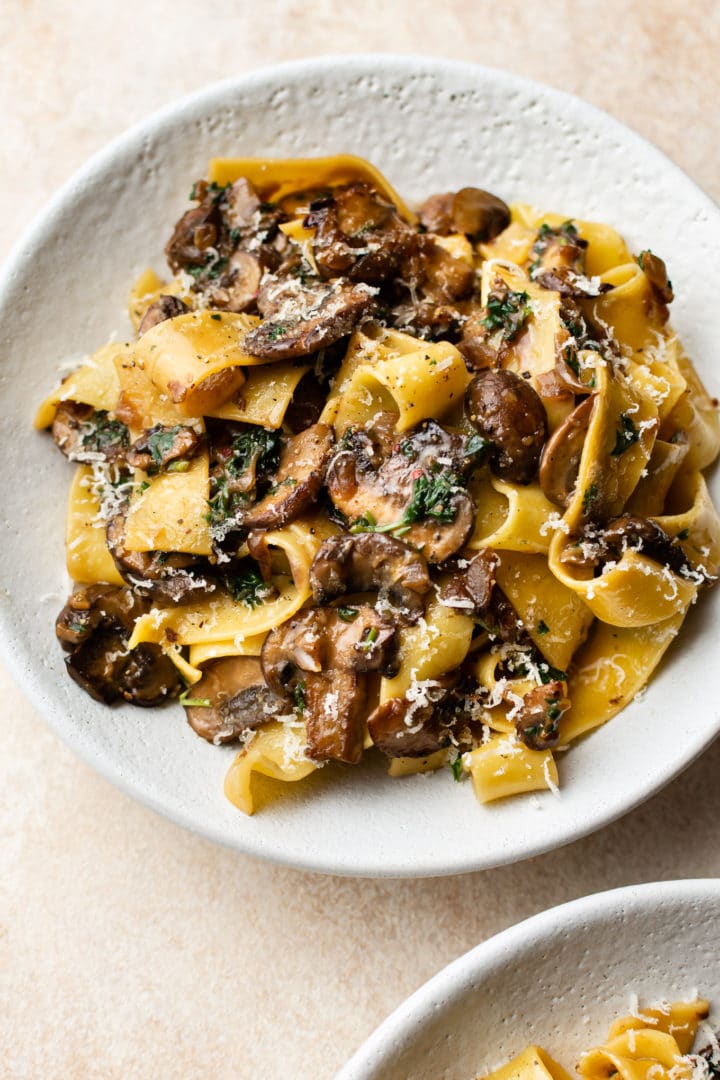 garlic butter mushroom pasta in two white bowls