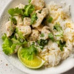 coconut lime chicken (2 bowls with chicken, sauce, cilantro, lime wedge, and rice)