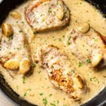 creamy garlic pork chops in a skillet