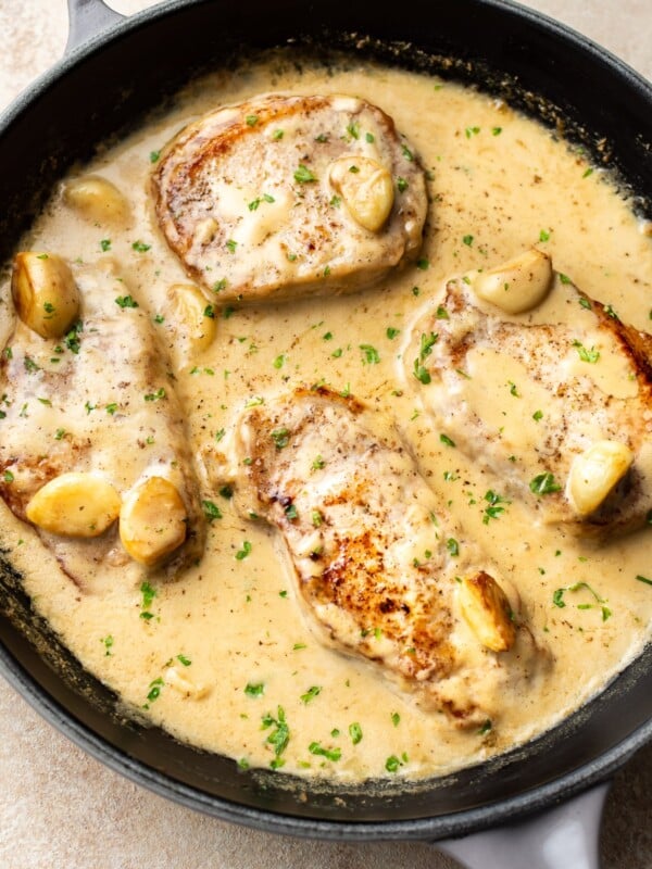 creamy garlic pork chops in a skillet