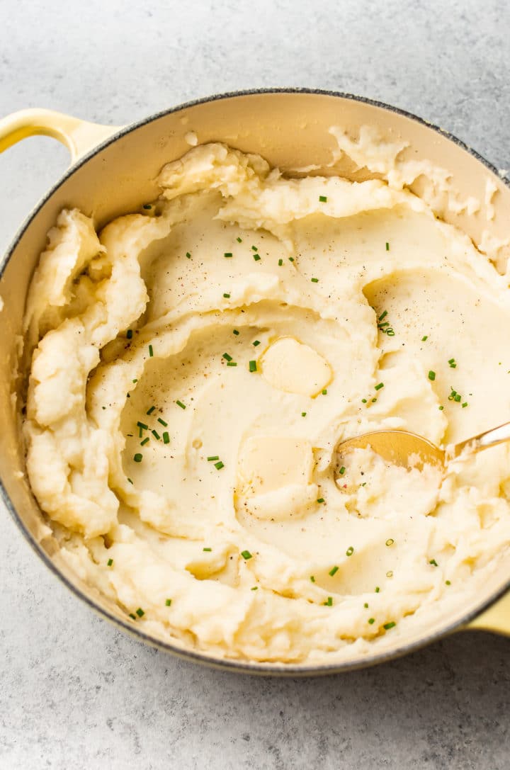 garlic mashed potatoes in a yellow Le Creuset pot