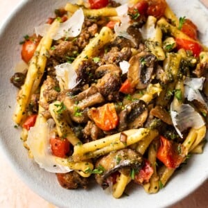 pesto sausage pasta in white bowl