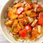 a bowl of pineapple chicken over rice