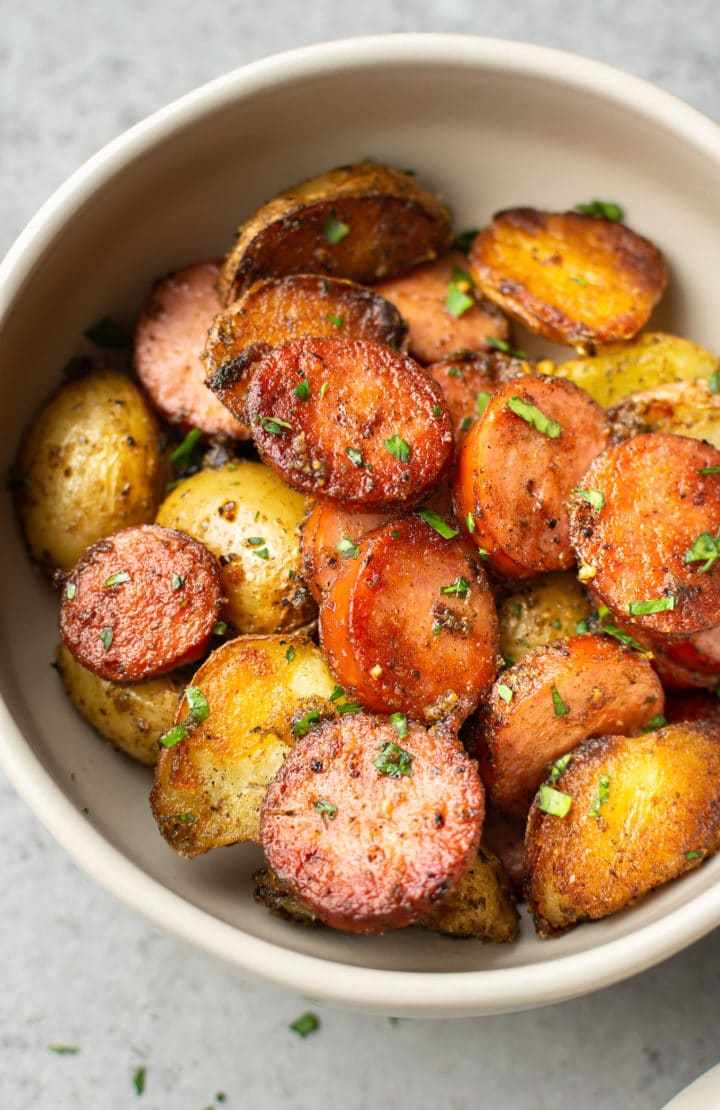 pan-fried sausage and potatoes close-up (in a bowl)