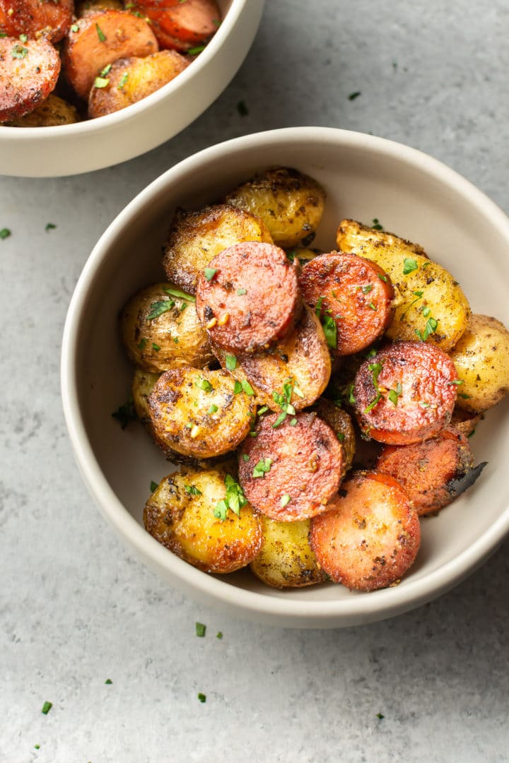 fried potatoes and smoked sausage in two bowls
