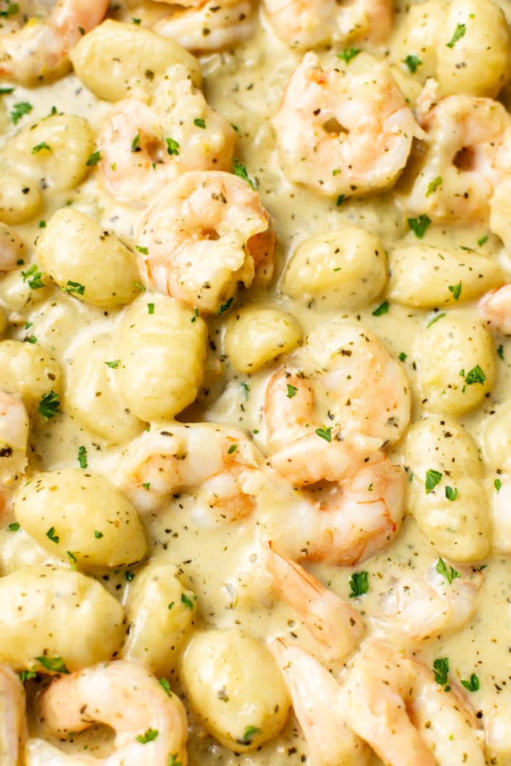 close-up of creamy pesto shrimp gnocchi