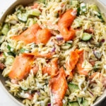 smoked salmon pasta salad in a beige serving bowl