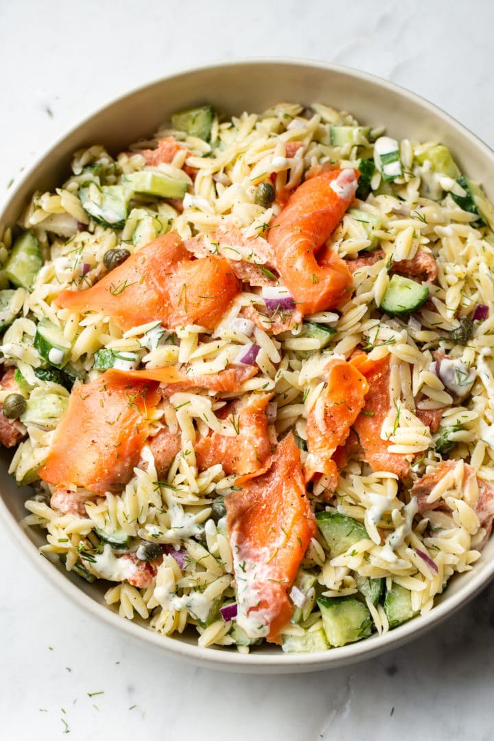 smoked salmon pasta salad in a beige serving bowl