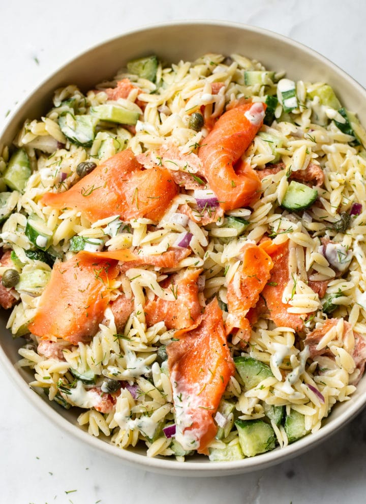 smoked salmon pasta salad in a beige serving bowl