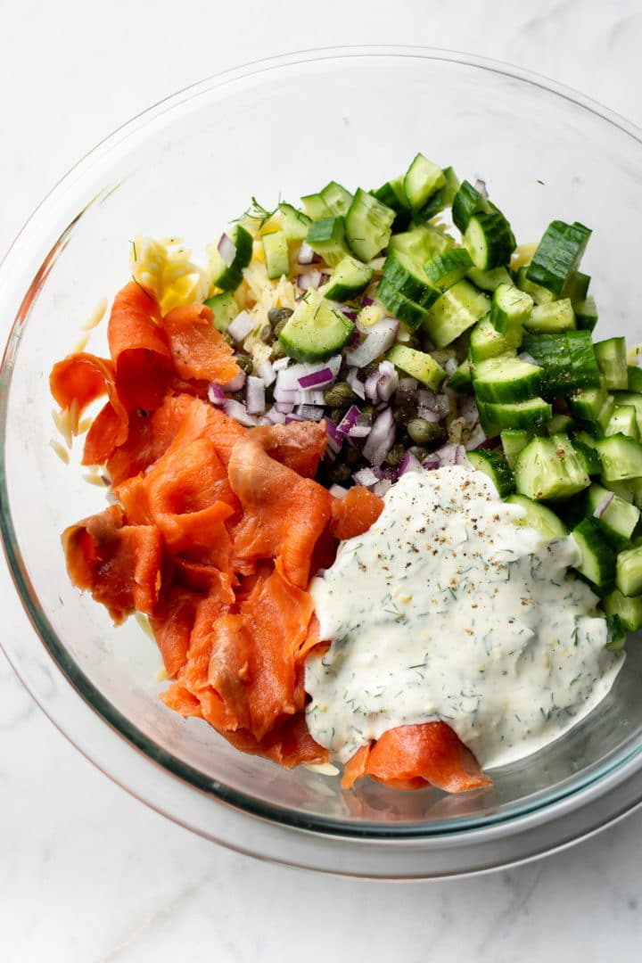 smoked salmon pasta salad ingredients in a glass prep bowl