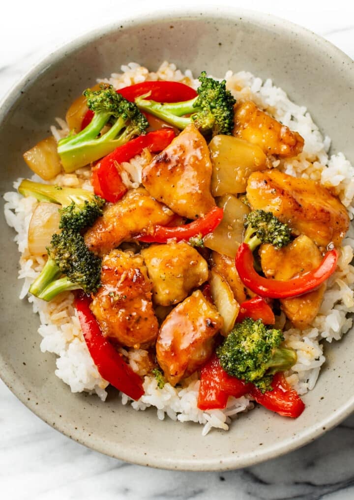 a bowl of teriyaki chicken stir fry over rice