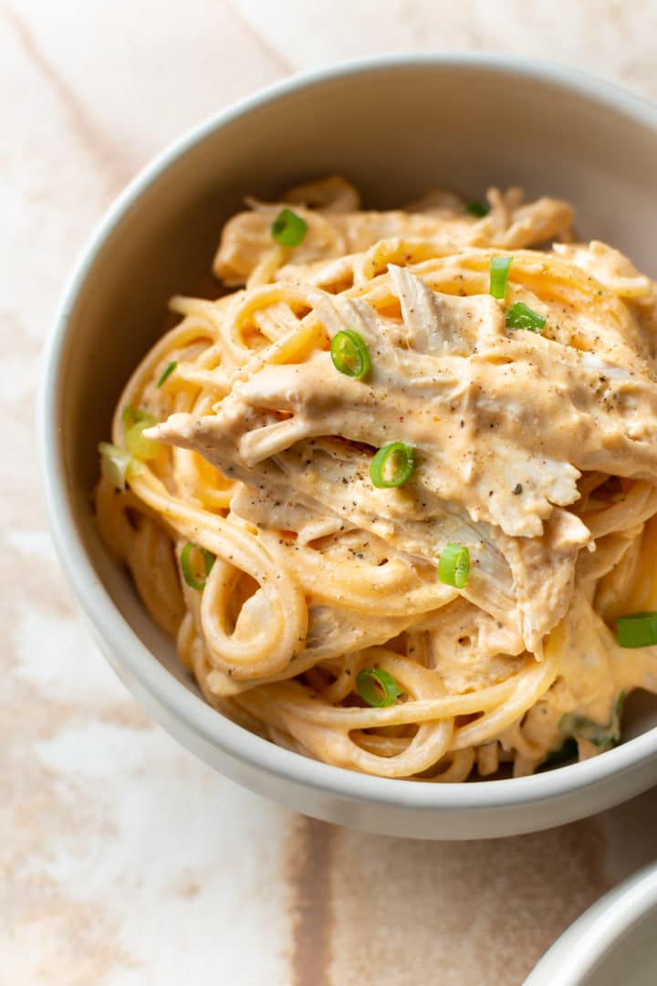 buffalo chicken pasta in a beige bowl