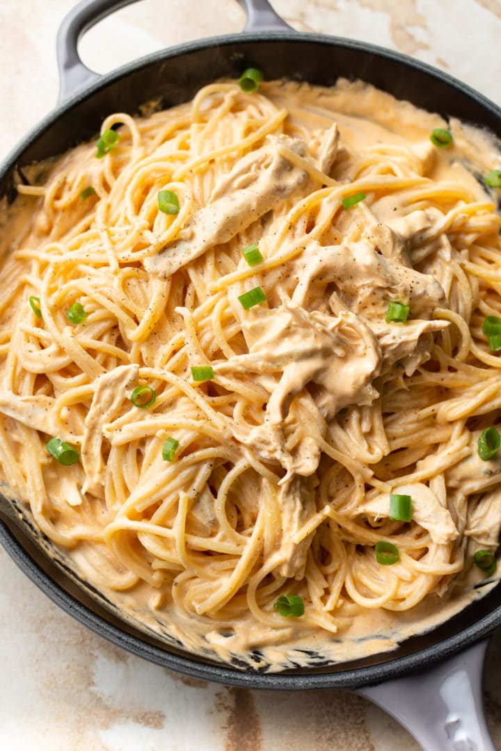 close-up of creamy buffalo chicken pasta (sauce and spaghetti) in a skillet