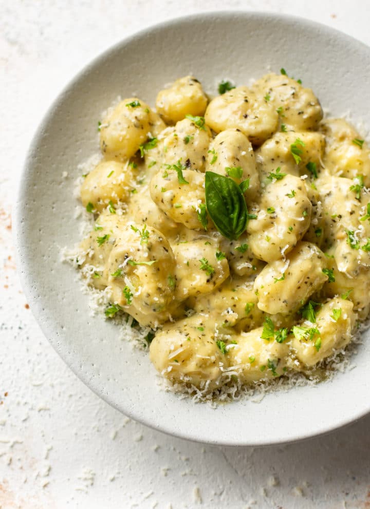 pesto gnocchi in a white bowl