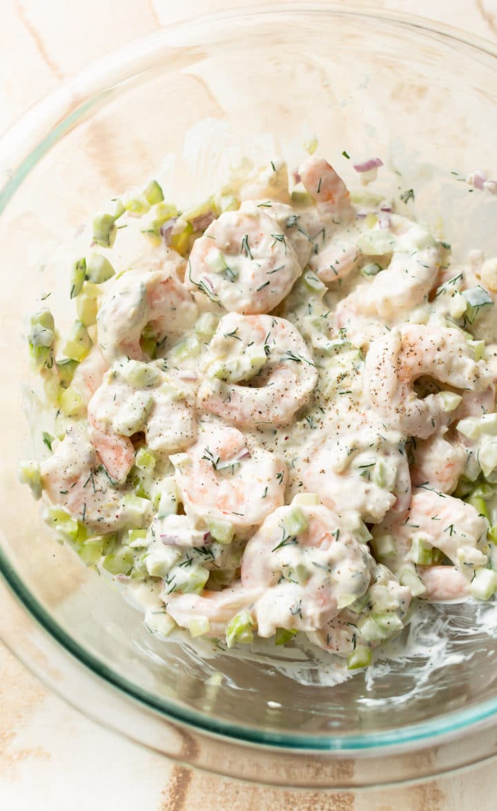 close-up of cold shrimp salad in a glass prep bowl