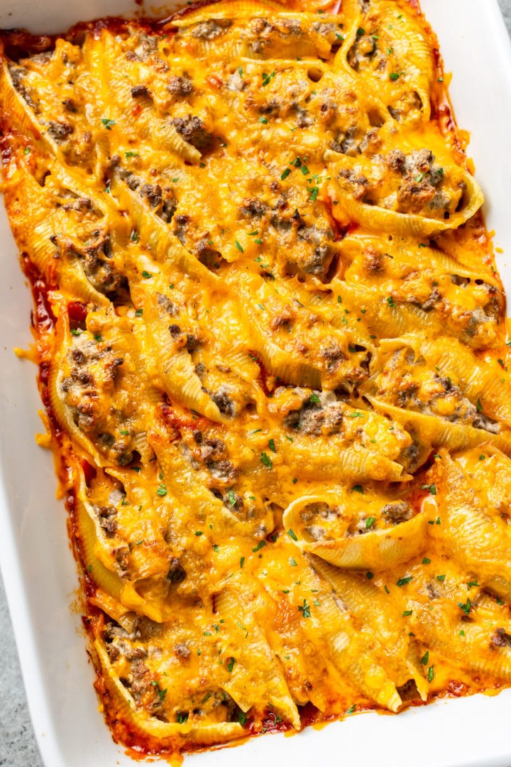 close-up of cheesy beef stuffed shells in a baking dish